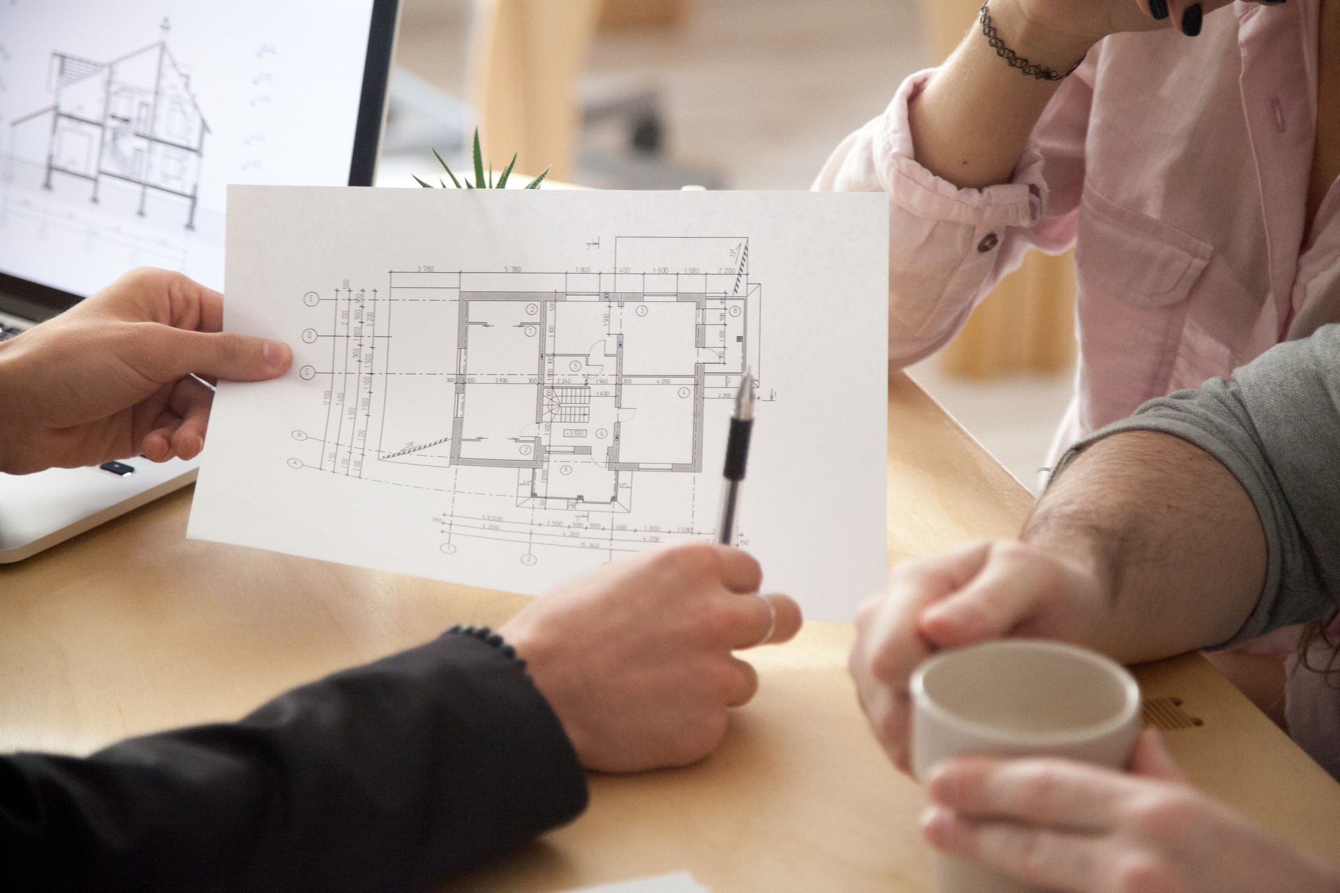 Architect, Real Estate Agent or designer consulting couple with apartment plan, closeup